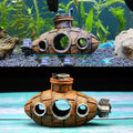 Ornement sous-marin bronze installé dans un aquarium